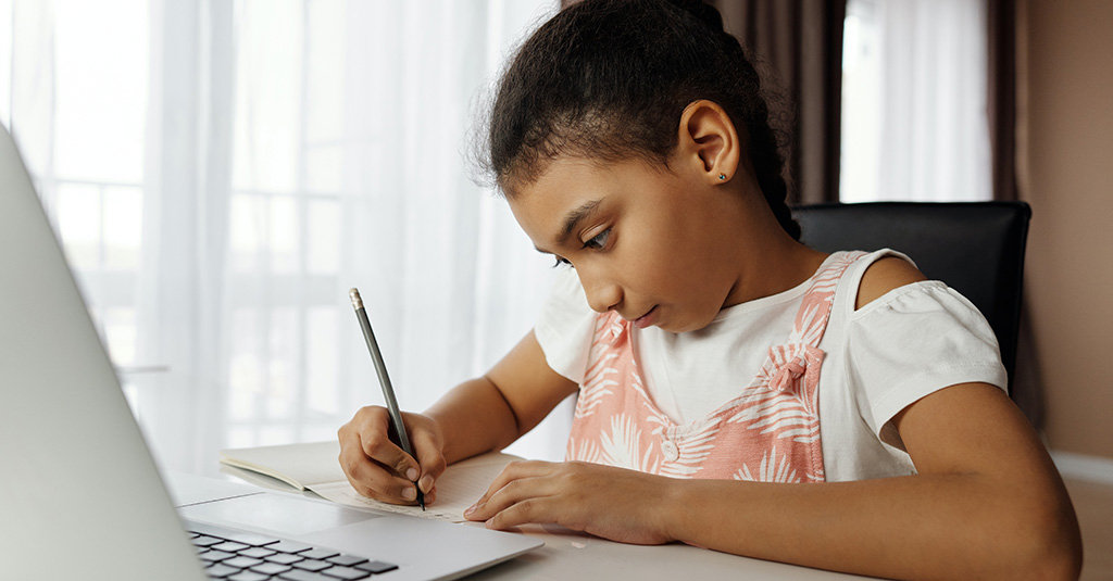 Young girl doing online school work.